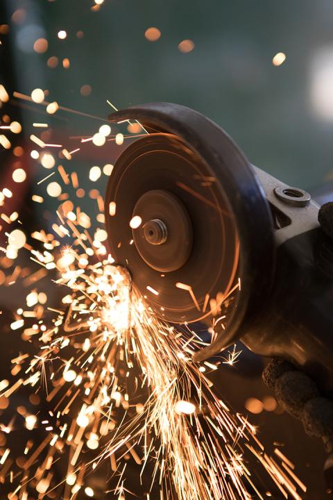 Image of student welding with sparks flying